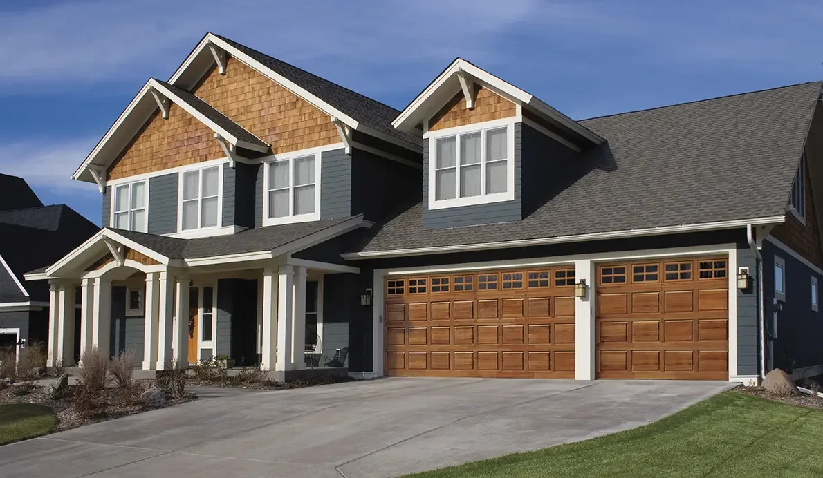 Cedar wood garage doors with short windows on a craftsman home.